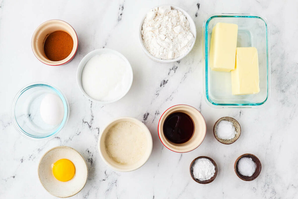 Ingredients for sourdough snickerdoodles on a white counter.