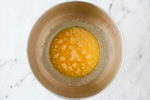 Adding the browned butter to the mixing bowl.
