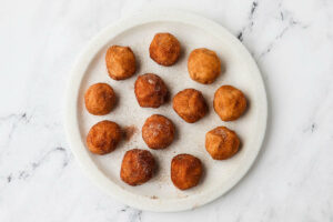 Balls of cookie dough rolled in cinnamon sugar.