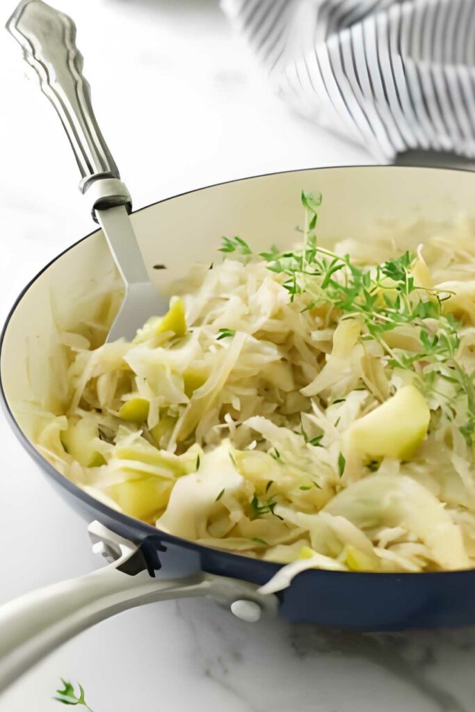 Cooked sauerkraut with apples in a skillet. 