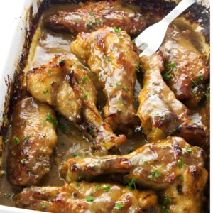 Glazed turkey wings in white dish, garnished with parsley.