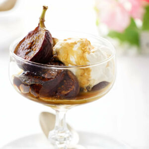 Caramelized figs in a dish with creme fraiche.