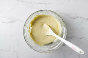 Folding flour into the pizzelle batter.