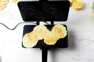 Freshly baked Italian pizzelle on the iron.