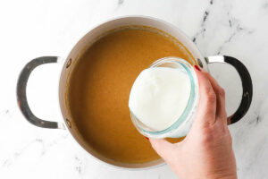 Adding the buttermilk to the mixture.