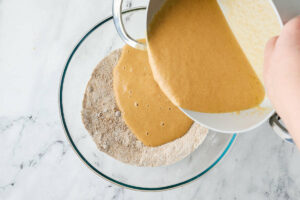 Adding the wet ingredients to the dry ingredients.