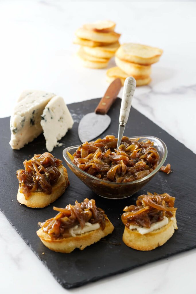 Onion marmalade on an appetizer tray with cheese and toast.