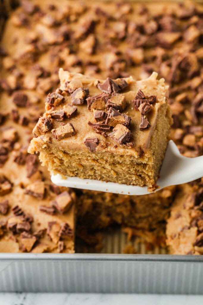 A spatula lifting a serving of peanut butter butter cake.