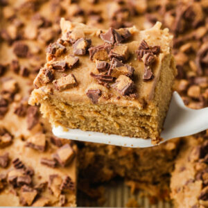 A spatula lifting a slice of peanut butter cake and icing.