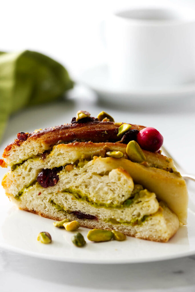 A slice of pistachio babka with cranberries.