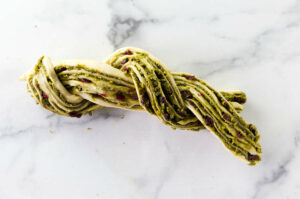 Twisting two pieces of dough together.