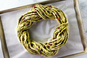 Placing the babka wreath on a baking sheet.