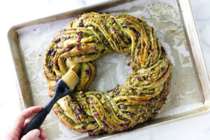 Brushing a glaze over the pistachio babka.