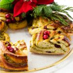 A slice of pistachio and cranberry babka shaped in a wreath.