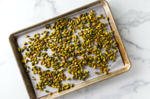 Toasting pistachios on a sheet pan.