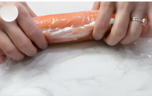 Rolling the salmon and cream cheese into a log.