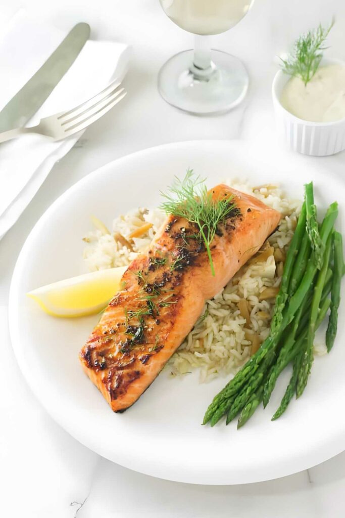 Copper river salmon on rice with dill, asparagus, lemon, and white wine.