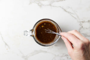 Whisking the sauce for the noodles.