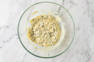 Folding chocolate chips into the cream cheese mixture.