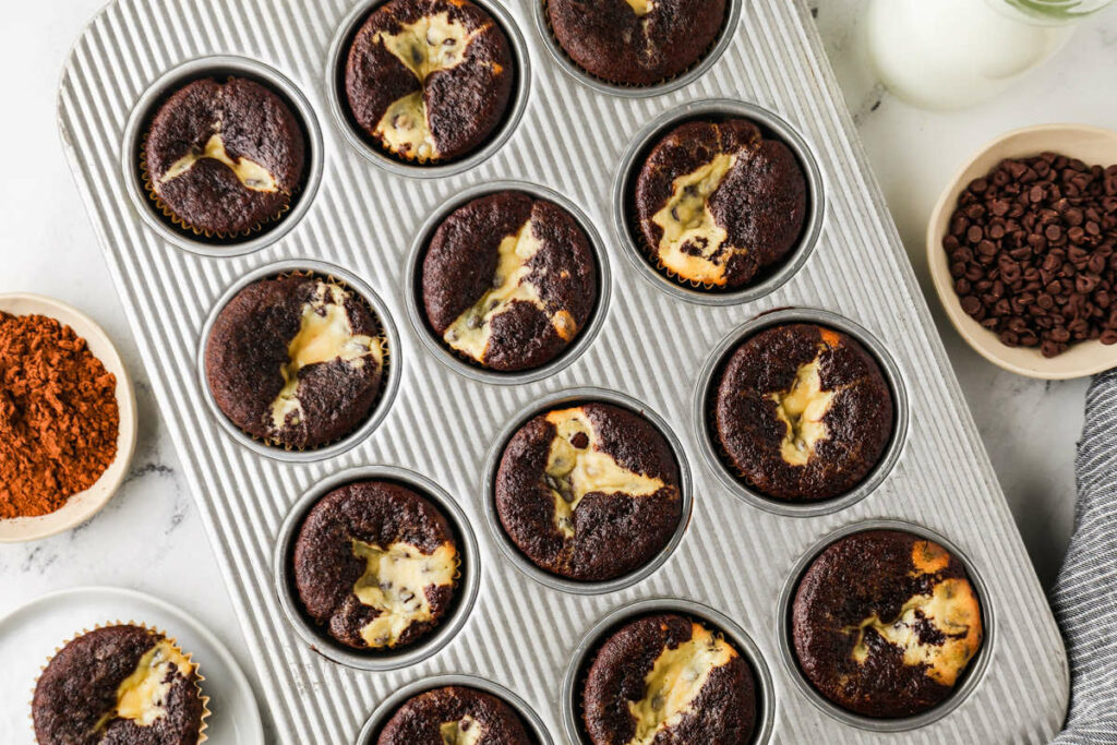A cupcake baking pan filled with chocolate cream cheese cupcakes.