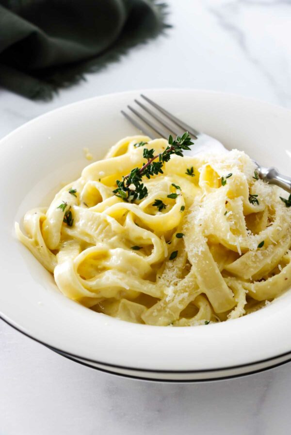 A pasta bowl filled with fettuccini alfredo.