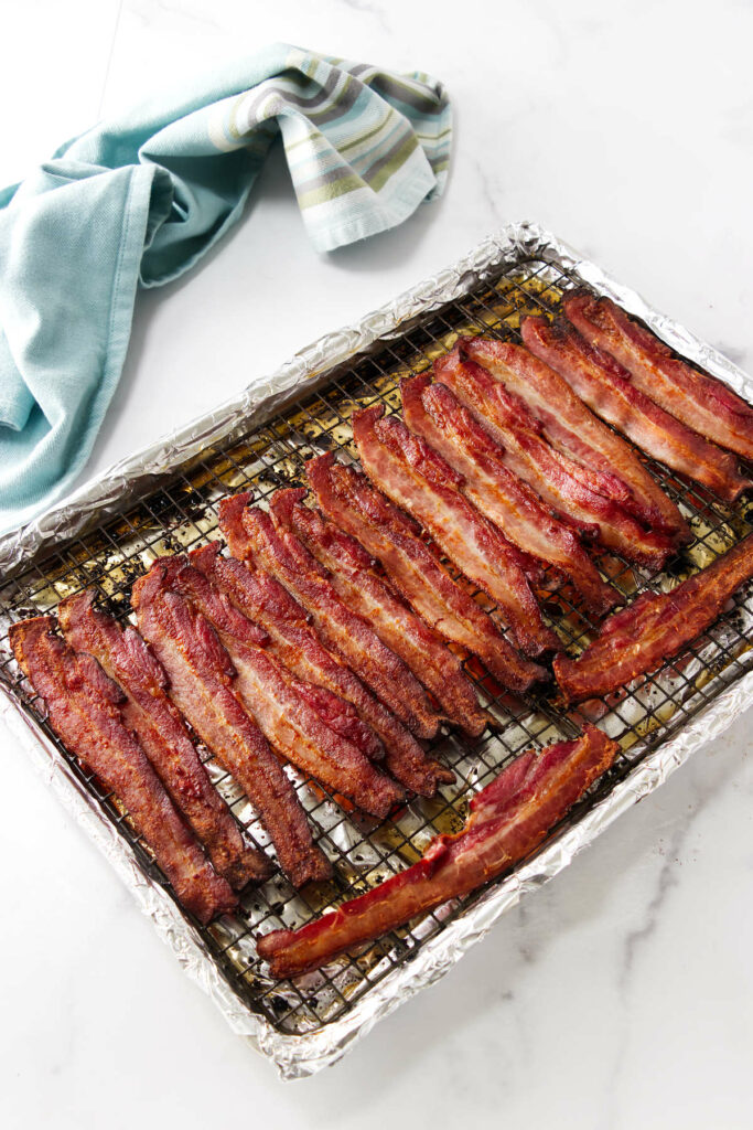 Freshly cooked bacon on a sheet pan.