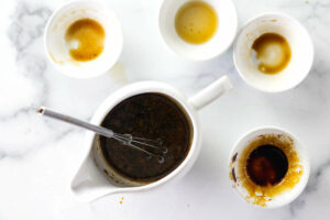 Mixing soy sauce with oyster sauce and sesame oil.
