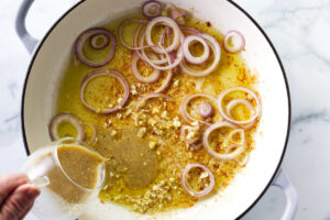 Adding the vinaigrette to the skillet.
