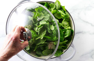 Adding a lid to the skillet.