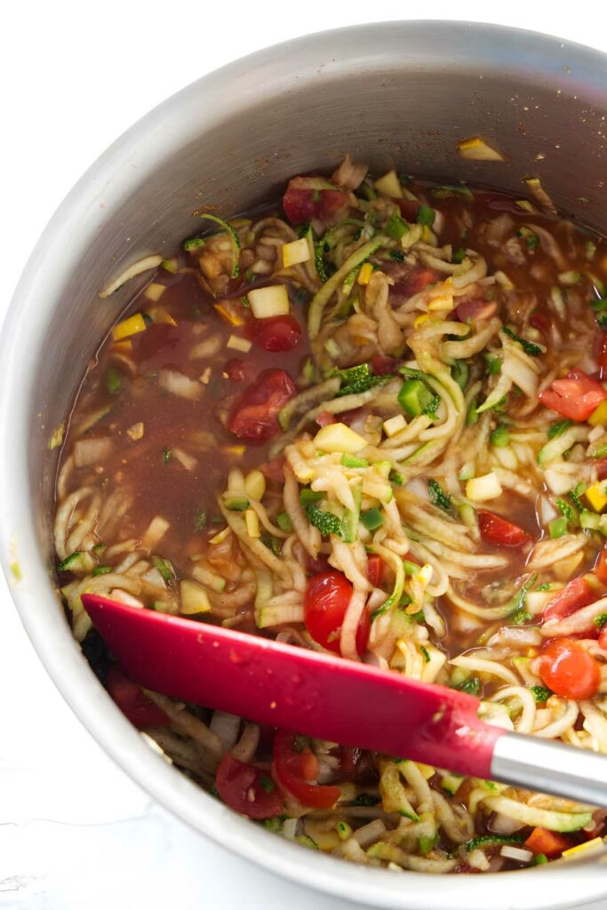 Pot of zucchini salsa with tomatoes on the stovetop. 