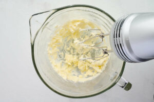 Beating the butter with a mixer.
