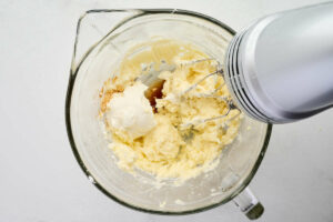 Beating sour cream into frosting.