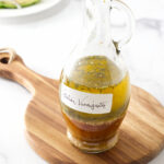 A tall bottle of homemade Italian vinaigrette dressing.