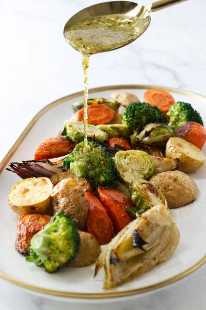 Drizzling Italian vinaigrette over roasted mixed veggies.