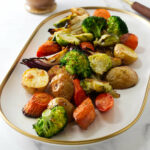 Roasted mixed vegetables on a white serving platter.