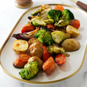 Roasted mixed vegetables on a white serving platter.