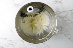 Whipping butter in a mixing bowl.