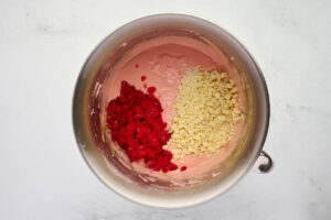 Mixing maraschino cherries and white chocolate chips into cake batter.