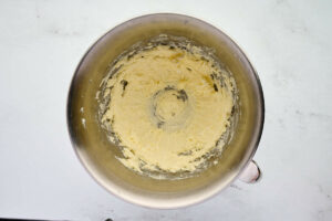 Whipping butter in a mixing bowl.