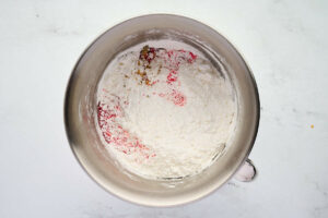 Adding powdered sugar to buttercream.