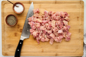 Cutting chicken into bite size pieces.