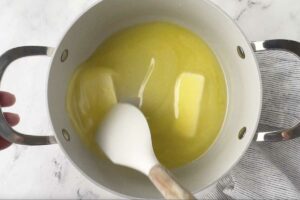 Melting the butter for the fudge icing.