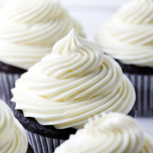 A swirl of sour cream frosting on top of mini cakes.