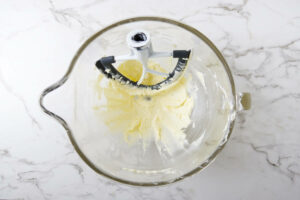 Beating butter in a mixing bowl.