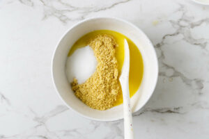 stirring butter and sugar into cookie crumbs.