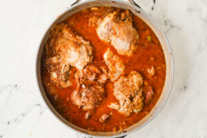 Simmering chicken in a rich gravy.