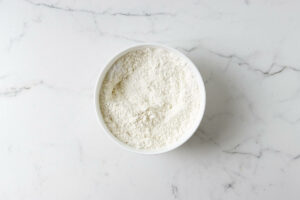 Combining flour and salt in a bowl.