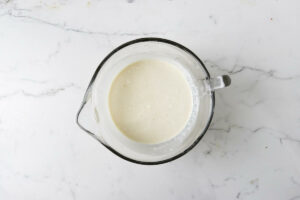 Mixing three types of milk together in a bowl.