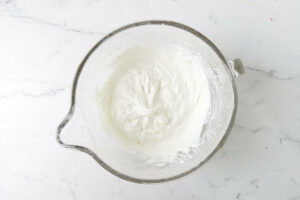 Freshly whipped cream in a mixing bowl.