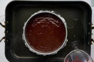 Placing the baking pan in a water bath.